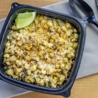 Street Corn · Roasted corn kernels, chipotle crema, spicy chili lime, cotija cheese & lime wedge.