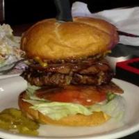 Western Burger · Piled high with two bacon strips, golden onion rings, cheddar cheese, and BBQ sauce. Served ...