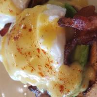 Western Benedict · Toasted english muffin topped with bacon, avocado, poached eggs, and hollandaise sauce serve...