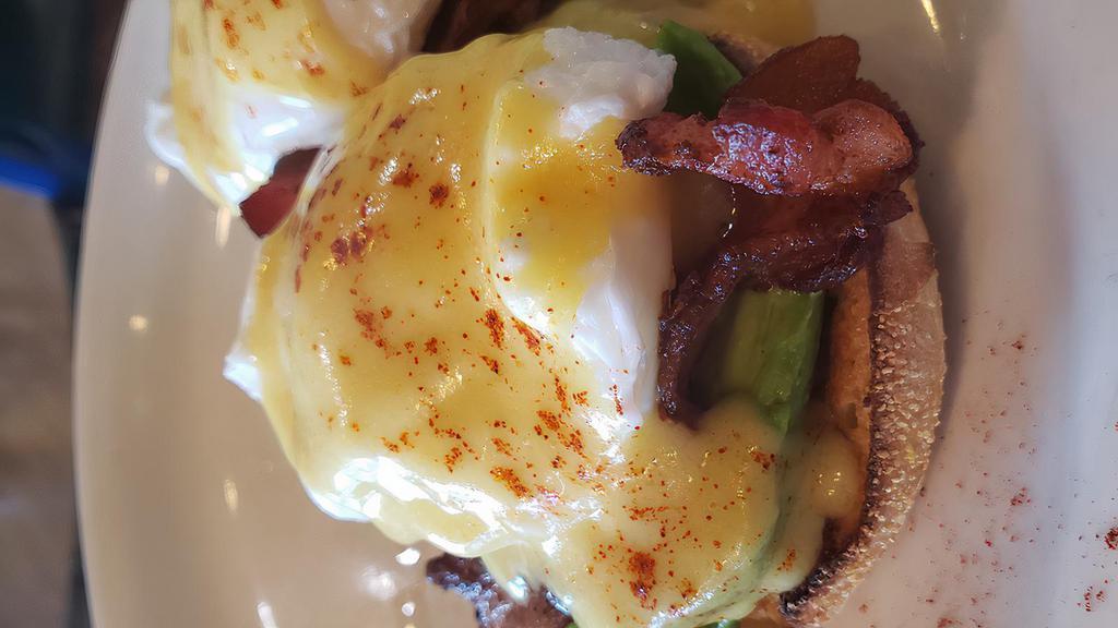 Western Benedict · Toasted english muffin topped with bacon, avocado, poached eggs, and hollandaise sauce served with home fries.