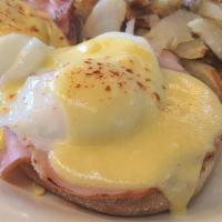 Eggs Benedict · Toasted english muffin with poached eggs and Canadian bacon topped with hollandaise, served ...