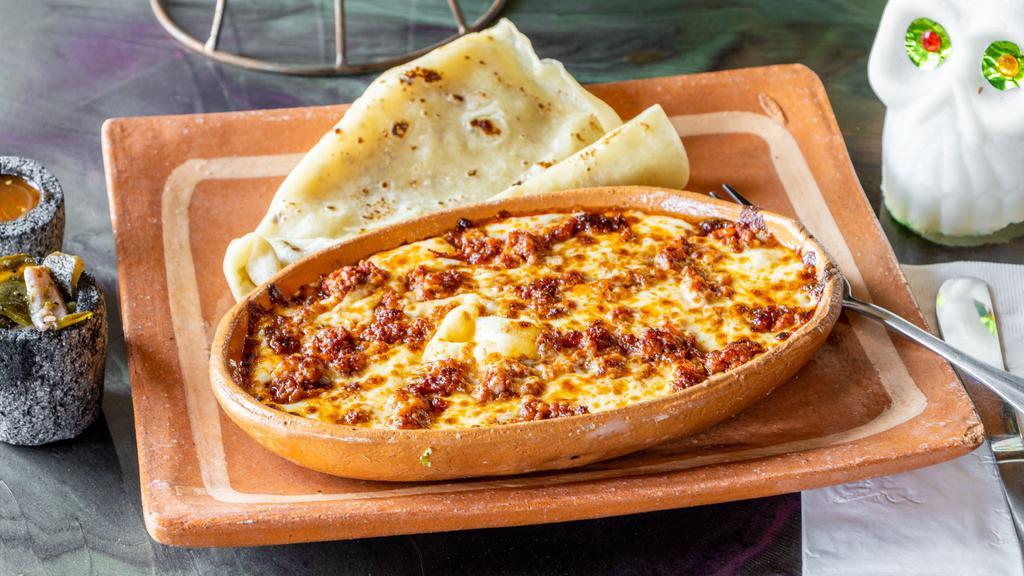 Queso Fundido · Oaxacan cheese and goat cheese flameado. Choose one item of roasted red pepper, poblano, mushroom