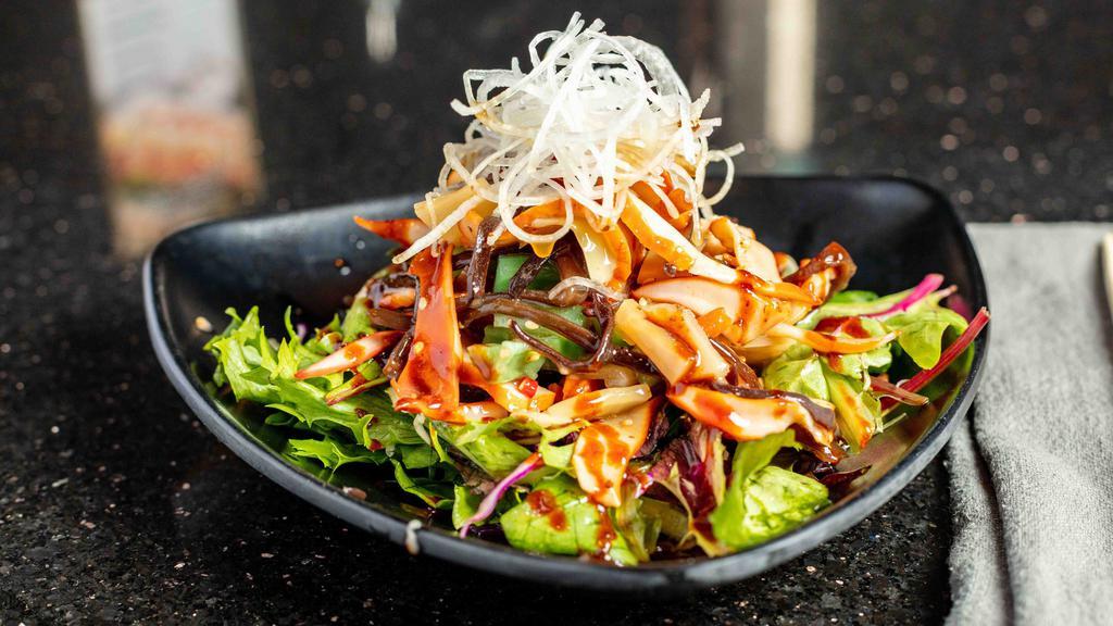 Spicy Squid Salad · Marinated squid in sweetly spicy sauce over greens.