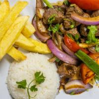 Lomo Saltado · Strips of beef sauteed with onions tomato, served with potato and rice.