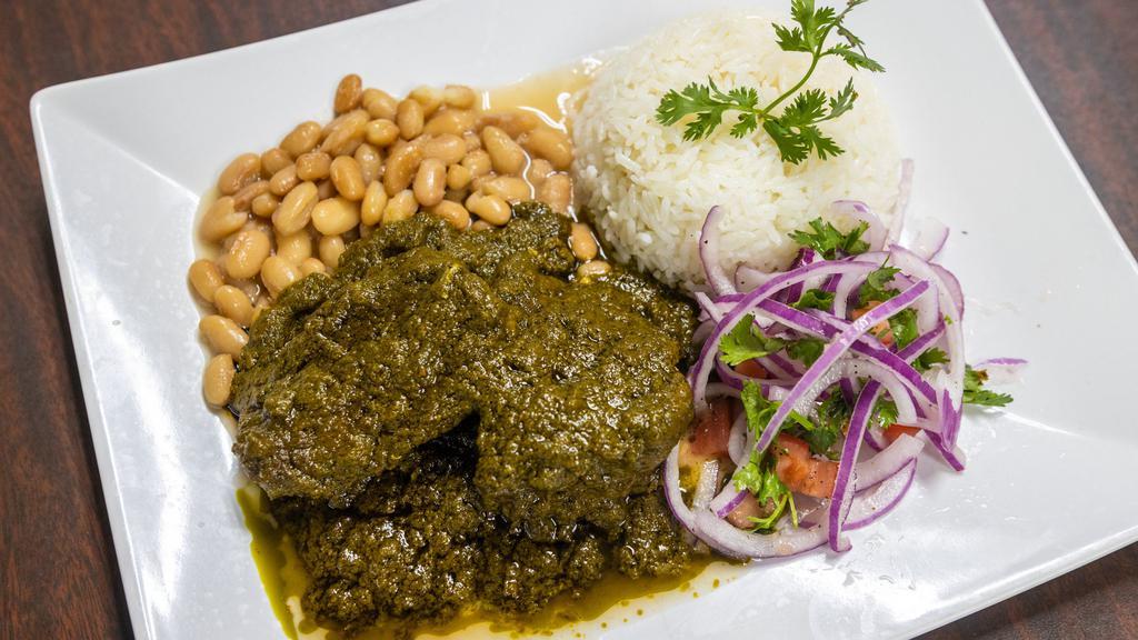 Seco Norteño · Beef slow cook in cilantro sauce, served with rice pinto beans and onions sauce.