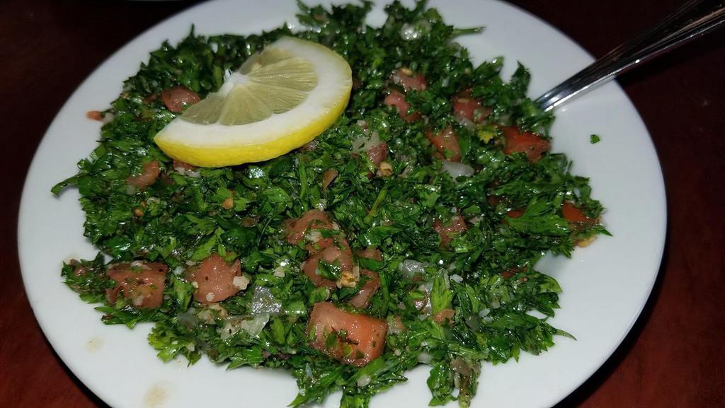 Tabouli · Vegetarian, vegan. Parsley, bulgur wheat, tomato, onion, and dry mint, mixed with olive oil and lemon juice.
