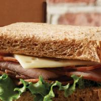 Trio Classic · 13 Grain. Roast beef, sliced turkey, ham, tomato, lettuce, and Swiss cheese. Served with sig...
