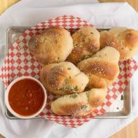 Garlic Knots · Six fluffy bread knots drenched in butter and garlic and sprinkled with Romano cheese. Serve...