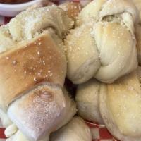 Garlic Knots · Our wonderful pizza dough tied in a knot drenched in butter and garlic and sprinkled with Ro...