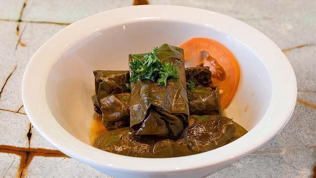 Veggie Grape Leaves · (dolmas) hand rolled grape leaves filled with bell peppers, rice, and pomegranate molasses. Served with tahini sauce. Vegan. Vegetarian. Gluten free.