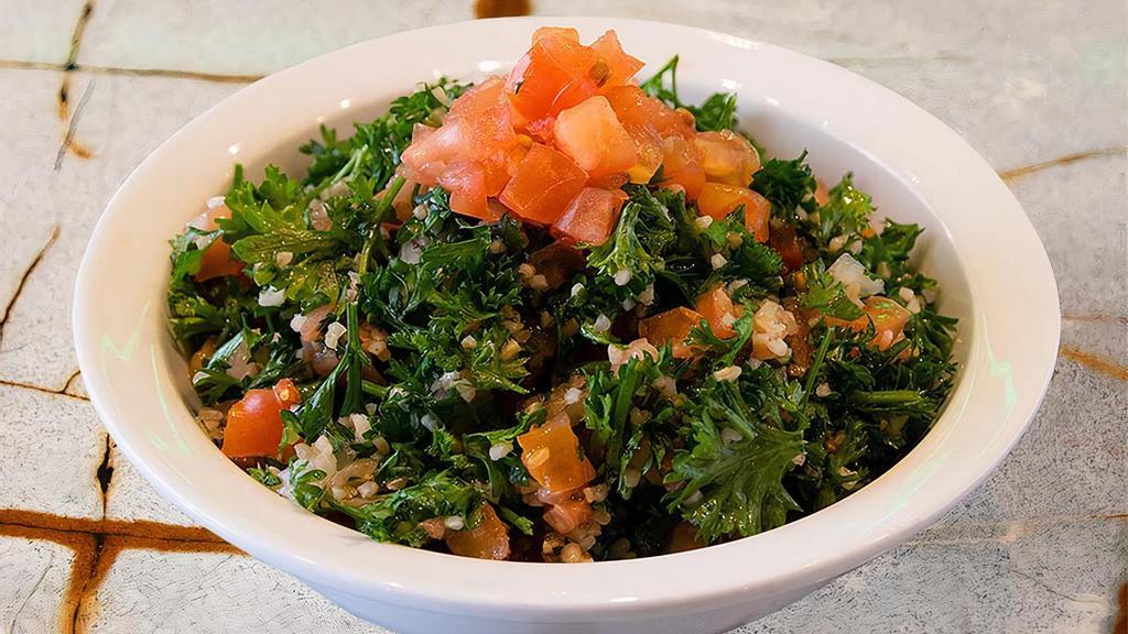 Tabouli (Veg) · Hand chopped curly parsley, tomatoes, and onions mixed with salt, pepper, lemon juice and extra virgin olive oil.