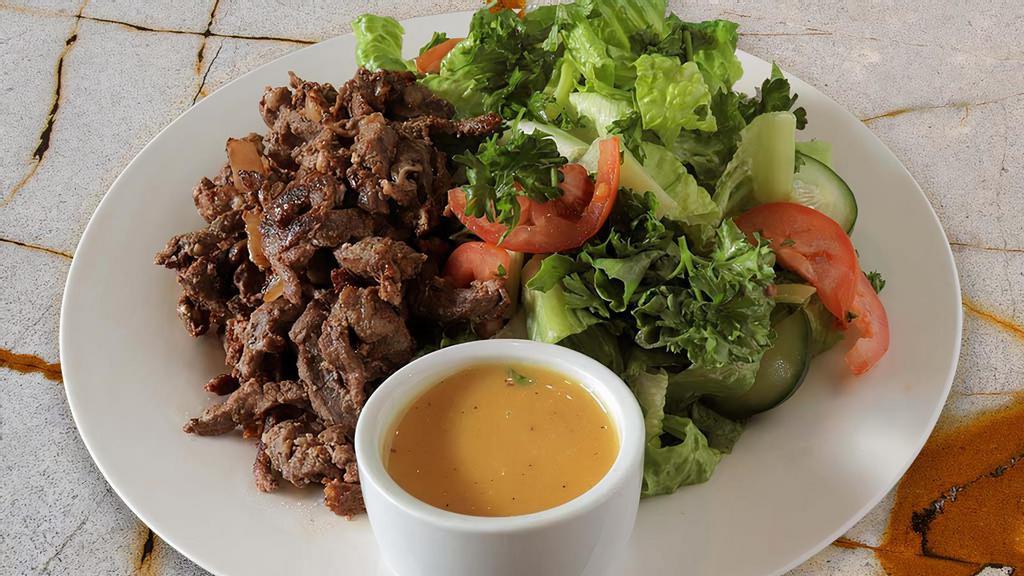 Lamb Shawarma Salad · Grilled lamb shawarma marinated with sautéed onions over crispy romaine lettuce, tomatoes, cucumbers, and parsley, with our tangy lemon garlic dressing. Gluten free.