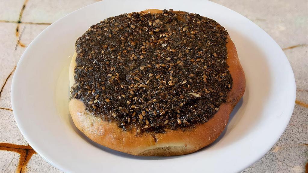 Zaatar (Veg) · Blend of middle eastern herbs, toasted sesame seeds and olive oil. Spread over our housemade dough and baked in our wood stone oven.