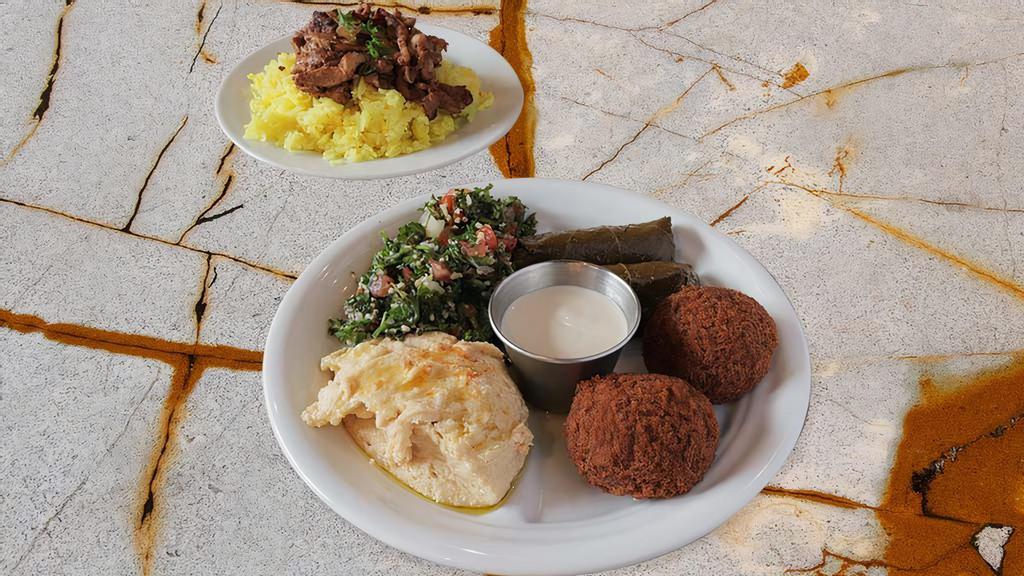 Grand Meat Mezza · Chicken shawarma, Kafta Kabob Skewer, tabouleh, hummus, meat stuffed grape leaves, falafel, arnabeet (cauliflower) and batenjan (stuffed eggplant with feta cheese) and majardra (rice and lentils) comes with one pita bread. Serves approximately two people.