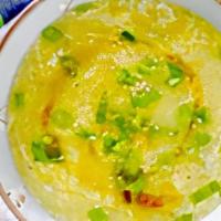 Egg Drop Soup · Wispy beaten eggs in a flavorful chicken broth with peas and carrots