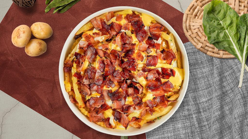 Bacon Cheese Fries · Idaho potato fries cooked until golden brown and garnished with salt, melted cheddar cheese, and bits of crispy bacon.
