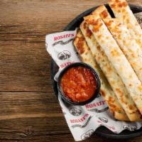 Cheesy Bread Stix · Breadsticks topped with garlic butter and mozzarella cheese & served with a side of marinara.