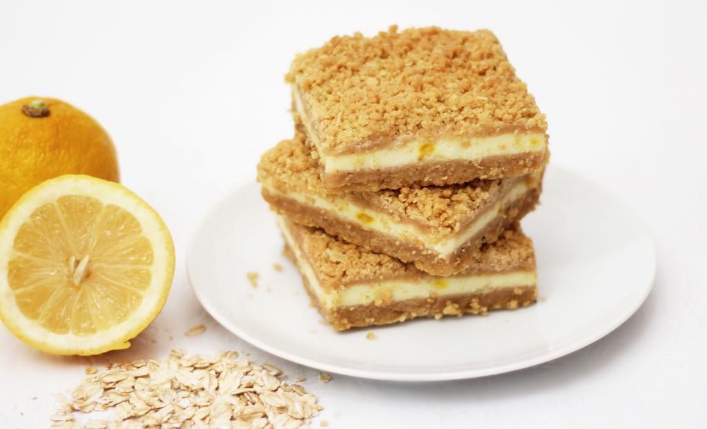 Lemon Oatmeal Bar · Gentle rich lemon filling between sweet oatmeal layers.  Box of twelve bars. Baked in a facility that uses dairy, nuts, and wheat products.