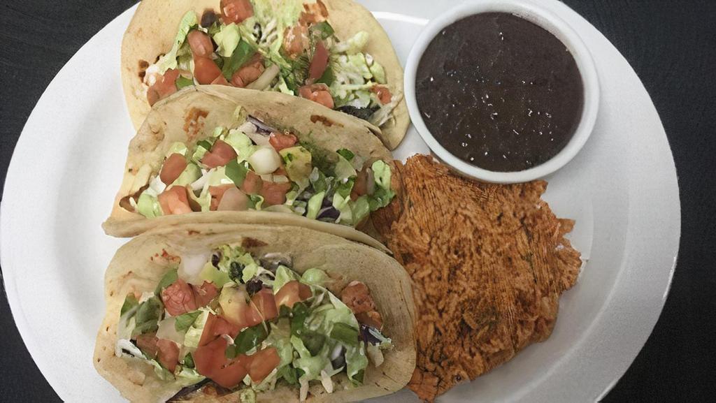 Grilled Fish Tacos · Choose between two or three corn tortillas stuffed with grilled fish, shredded cabbage, pico de gallo and homemade avocado crema. Served with rice and black beans.