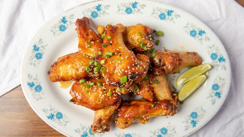 Chili-Garlic Chicken Wings · Chicken wings slow-roasted then fried crispy, tossed with chili, garlic, fish sauce, lime juice, and crushed peanuts.