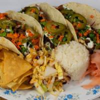 Bulgogi Beef Tacos · Seared thin-sliced bulgogi beef, pickled carrots, cilantro, jalapeño, scallions, and wasabi ...