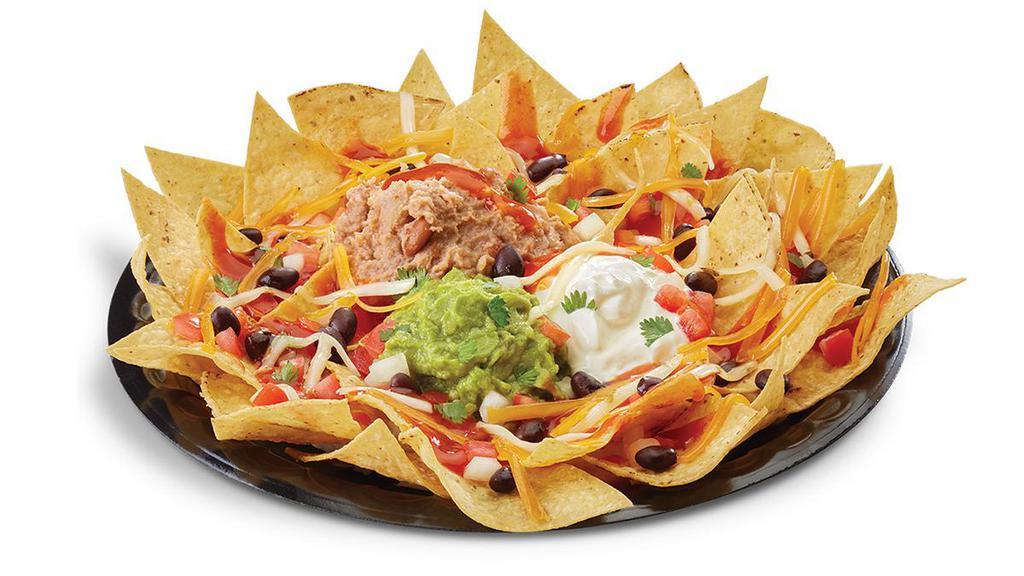 Nachos Grande · Original, seasoned beef or chicken; homemade corn tortilla chips smothered with refried pinto beans, cheddar, and pepper jack cheese, zesty enchilada sauce, and black beans. Topped with sour cream, salsa fresca, and guacamole.