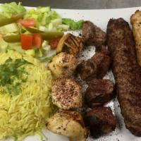Mixed Grill · Four skewers: lamb tikka, chicken tikka, chicken kabobs and mixed meat kabobs with rice, sal...