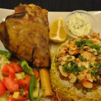 Lamb Shanks Over Rice · Large tender shanks with bones, served with broth, rice, and salad and tzatziki sauce.