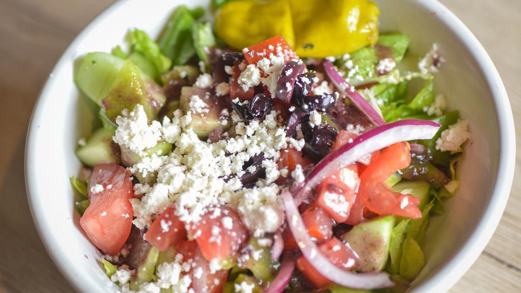Greek Salad · Lettuce, tomatoes, cucumbers, onions, green peppers, feta cheese, olives tossed with Greek dressing.