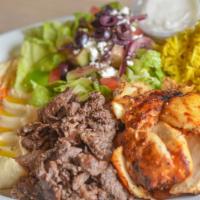 Mix Shawarma · Sliced marinated beef, served with rice, Greek salad, hummus, pita bread, and garlic sauce o...