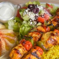 Chicken Kabab · Two‎ skewers of chicken kabab, served with grilled green peppers, and tomato rice, Greek sal...