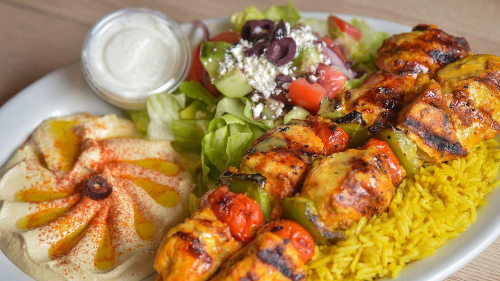 Chicken Kabab · Two‎ skewers of chicken kabab, served with grilled green peppers, and tomato rice, Greek salad, hummus, pita bread and garlic sauce.