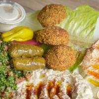 Vegetarian Plate · Three pieces of crispy falafel, hummus, tabouleh salad, baba ghannoug, two stuffed grape lea...