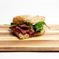Flank Steak Sandwich · Flank steak, red chimichurri, Altius Farms arugula, aioli, and caramelized onions on City Ba...