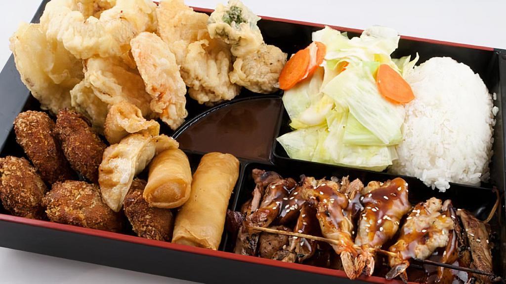 *Bento Sampler · A sampler of our favorite appetizers. This dish includes yaki prawns, chicken teriyaki, mini balls, spring rolls, gyoza, vegetable tempura, rice and steamed vegetables served in a bento style box!
