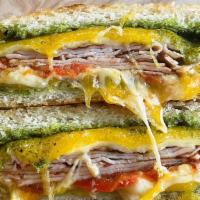 Rachel’S Melt · Grilled turkey breast, house-made basil pesto, gruyere, cheddar & Parmesan cheese grilled to...
