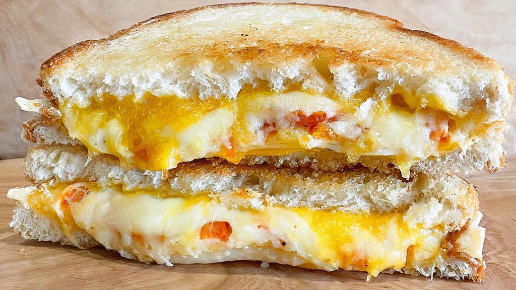 Ultimate Grilled Cheese Melt · Gruyere, cheddar & Parmesan cheese grilled to perfection with roasted tomatoes. Choice of bread.