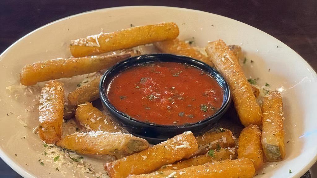 Fried Zucchini · Breaded zucchini sticks fried golden brown and topped with our famous Mizithra cheese.  Served with Marinara Sauce.