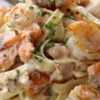 Seafood Fettuccine · premium white gulf prawns, bay scallops, sautéed fresh salmon and fettuccine tossed with cre...