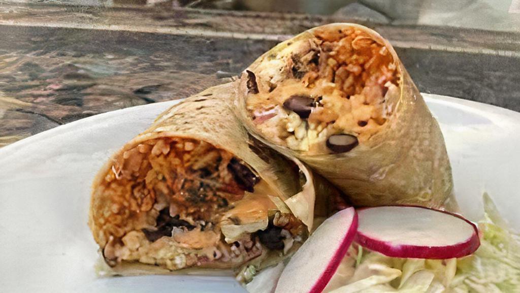 Coliflor Burrito · Chimichurri roasted cauliflower, cabbage, pickled onions, chipotle aioli, cotija, cilantro, spanish rice, black beans