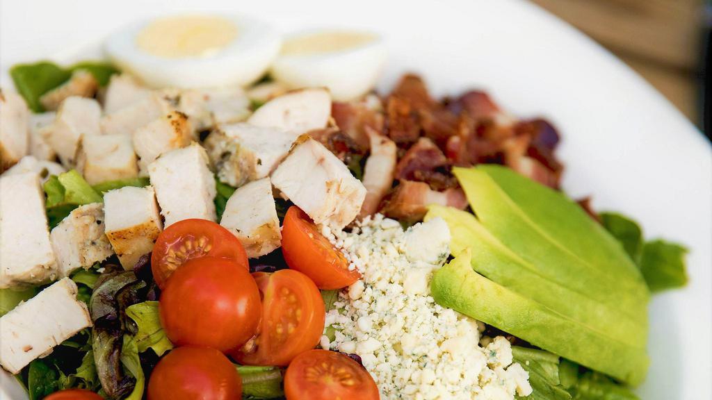 Pom Cobb · chopped romaine, organic greens, hempler’s bacon,  grilled chicken, avocado, hard boiled eggs, cherry tomatoes & blue cheese crumbles with mustard vinaigrette