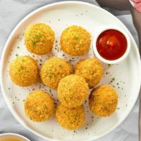Cheesy Mac Bites · 10 Bite-size clumps of mac and cheese breaded and fried until golden brown. Served with your...