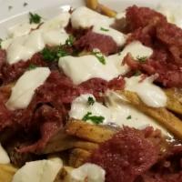 Irish Nachos · Hand cut potato chips, bone broth gravy, cheddar, and corned beef