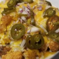 Westbound & Down · Tater tots skillet covered with green chili, cheese, onions, jalapenos