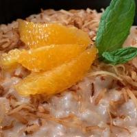 Coconut Rice Pudding · Creamy coconut rice pudding topped with toasted coconut and fresh orange slices