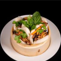 Grilled Pork Bao · Grilled lemongrass pork, cilantro, pickled vegetables, topped with crispy shallots and crush...