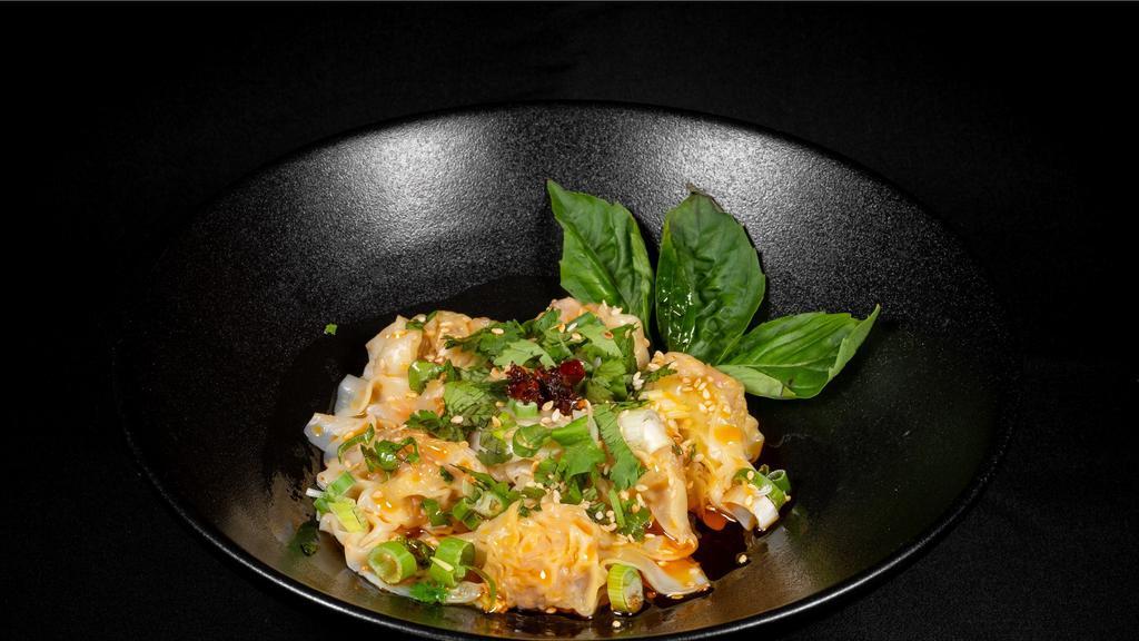 Wontons In Chili Oil · Pork and shrimp wontons in house chili oil, topped with crispy garlic, toasted sesame seeds, cilantro.