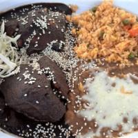 Chicken Mole · Spicy. 2 chicken pieces smothered with a rice sauce made from chocolate, peanuts, dry prunes...