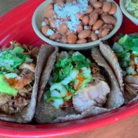 Traditional Carnitas · Pork confit, onion, cascabel chile, avocado salsa, cilantro.