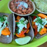 Boniato · Sautéed yams, onions, corn, roasted peppers, cotija cheese, avocado crema, cilantro.